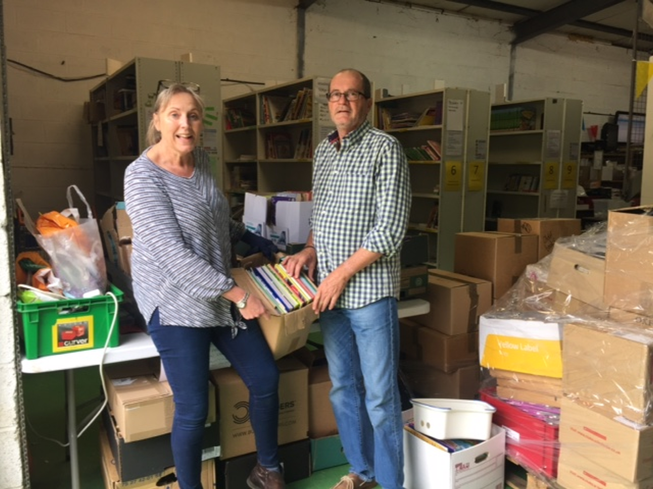 Clare Junak receives book donation from Peter Dobson