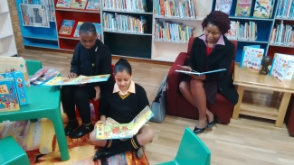 Students and their teacher reading in a new library