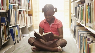 Girl reading at the library